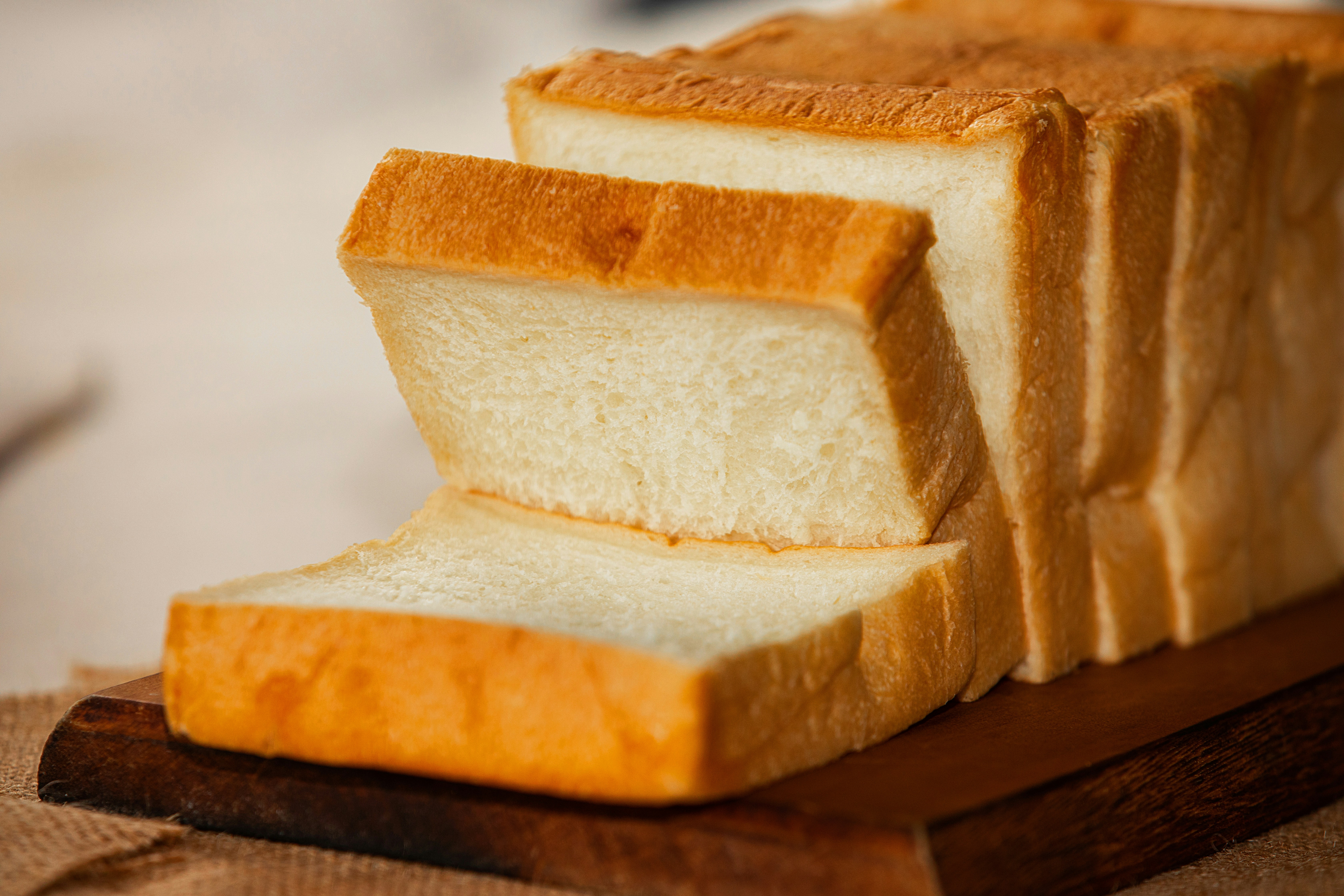 Fresh sliced bread on a wooden board